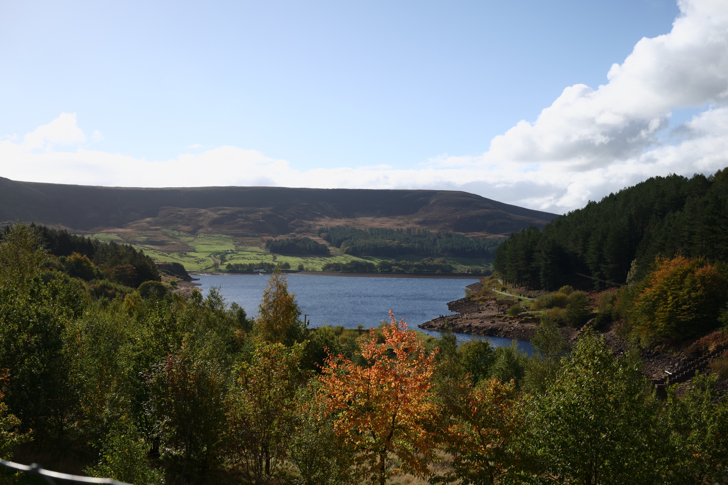 Dovestone Reservoir and the Saddleworth moors framed by autumn trees